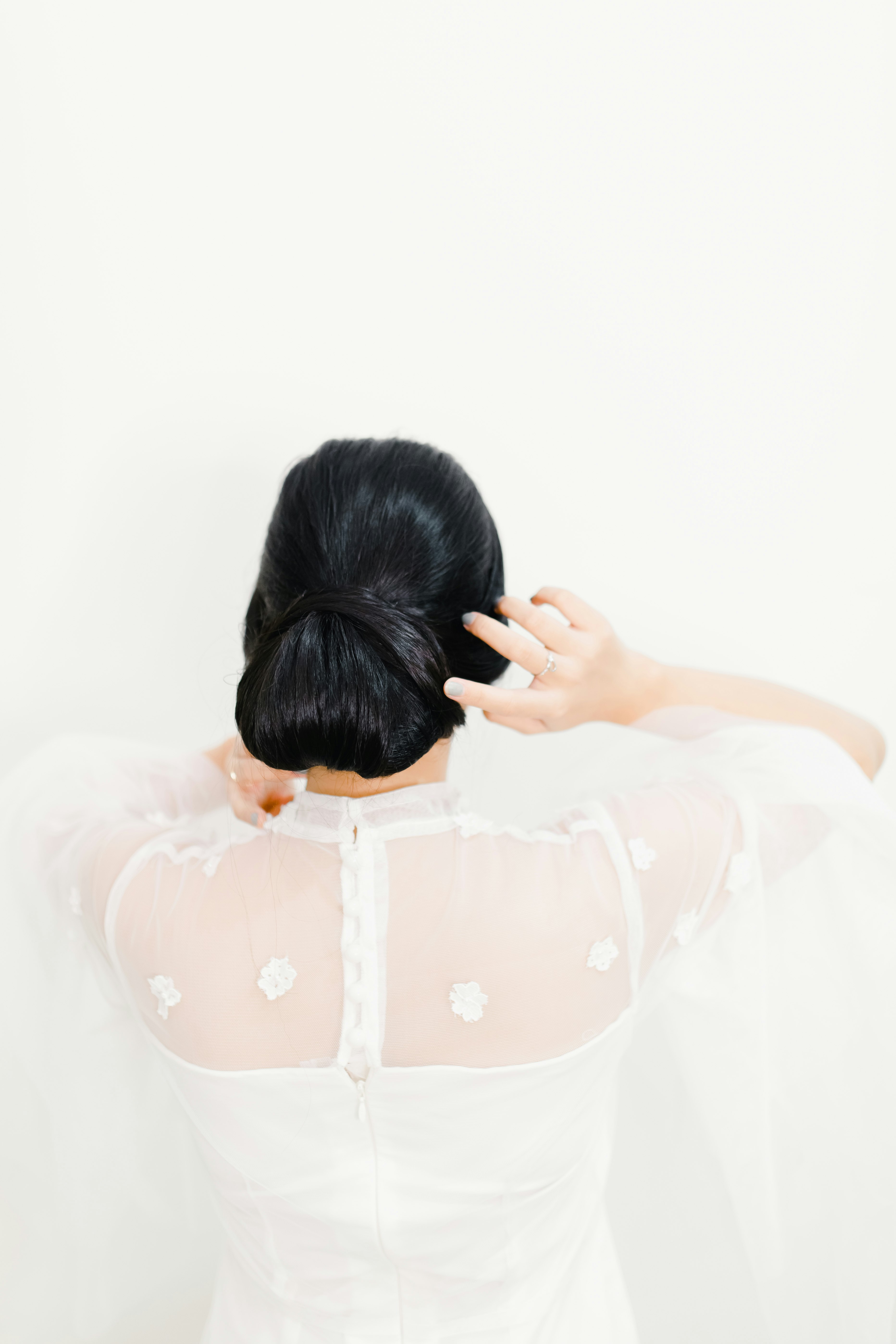woman in white dress covering her face